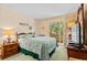 Comfortable bedroom with a queen-size bed and sliding door access to the screened-in patio at 9501 Shore Dr. # B-224, Myrtle Beach, SC 29572