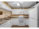 Bright kitchen with white cabinetry, laminate counters, and modern appliances at 9501 Shore Dr. # B-224, Myrtle Beach, SC 29572