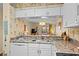 Updated kitchen with granite countertops offering a view into the living room at 9501 Shore Dr. # B-224, Myrtle Beach, SC 29572