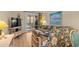 Comfortable living room with floral sofa and sliding glass doors leading to a screened-in porch at 9501 Shore Dr. # B-224, Myrtle Beach, SC 29572