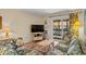 Cozy living room featuring floral print couches, wood floors, and access to an outdoor patio at 9501 Shore Dr. # B-224, Myrtle Beach, SC 29572