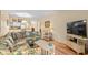 Cozy living room with a floral sofa, tv, and a view into the kitchen at 9501 Shore Dr. # B-224, Myrtle Beach, SC 29572