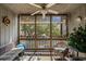 Relaxing screened-in porch with ceiling fan and views of mature trees and the complex parking lot at 9501 Shore Dr. # B-224, Myrtle Beach, SC 29572