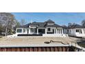 Rear exterior of a luxury home with covered patio and manicured landscape at 4302 Gray Heron Dr., North Myrtle Beach, SC 29582