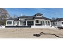 Rear exterior of a luxury home with covered patio and manicured landscape at 4302 Gray Heron Dr., North Myrtle Beach, SC 29582