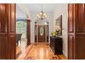 Elegant entryway featuring a chandelier, decorative wood flooring, and a stained glass front door at 1262 Limestone St., Murrells Inlet, SC 29576