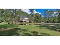 Spacious backyard with a pond and lush green grass at 7101 Choppee Rd., Georgetown, SC 29440