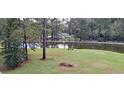Serene pond with a grassy area and a bench at 7101 Choppee Rd., Georgetown, SC 29440