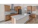 Modern kitchen with stainless steel appliances, granite countertops, light wood cabinets, and a kitchen island at 1228 Colusa Ct., Little River, SC 29566