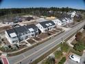 Aerial view of new townhome construction with landscaping and road access near forested area at 780 Maxine Ct. # 8E, Myrtle Beach, SC 29577