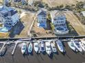 Aerial view of home on the marina, featuring a private dock with multiple boats at 1316 Marina Bay Dr., North Myrtle Beach, SC 29582