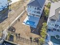 Aerial view of backyard with in-ground pool and fenced-in yard of this beautiful home at 1316 Marina Bay Dr., North Myrtle Beach, SC 29582