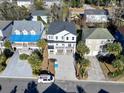 Aerial shot featuring the home's position in a beautiful neighborhood with palm trees at 410 5Th Ave. S, North Myrtle Beach, SC 29582