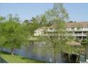 Tranquil pond view with lush green trees and gazebo at 510 Fairwood Lakes Dr. # 16M, Myrtle Beach, SC 29588