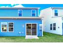 Light blue home with sliding glass door leading to a patio at 718 Nw Palm Frond Way # 66, Calabash, NC 28467