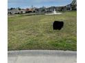 Photo of the grassy vacant lot with a For Sale sign at 2115 Mirabel Ct., North Myrtle Beach, SC 29582