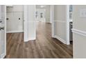 Bright hallway showcasing wood flooring, white trim, and a view into an airy, light-filled living space at 2729 S Key Largo Circle, Myrtle Beach, SC 29577