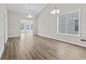 Spacious living room featuring wood floors, neutral walls, and ample natural light from the large windows at 2729 S Key Largo Circle, Myrtle Beach, SC 29577