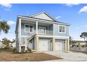 Charming two-story coastal home with a two-car garage and a lovely second-story balcony at 2307 Tortuga Ln., North Myrtle Beach, SC 29582