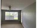 Bedroom with a view through a large window, ceiling fan, and direct patio access at 5020 Windsor Green Way # 103, Myrtle Beach, SC 29579