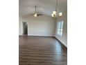 Spacious living room with wood-look flooring, fan, and abundant natural light at Tbd5 Privetts Rd., Conway, SC 29526