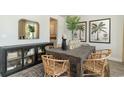Dining room boasts a wooden table with wicker chairs, complemented by stylish decor and artwork at 120 Fair Meadow Ct., Loris, SC 29569