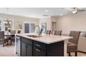 Kitchen island with seating, sink, and a view into the dining area at 578 Beckham Ct., Murrells Inlet, SC 29576