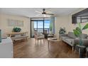 Cozy living room featuring tile floors, a ceiling fan, and large sliding glass doors with ocean views at 6804 N Ocean Blvd. # 1037, Myrtle Beach, SC 29572