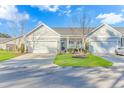 Two-story home with attached garage and manicured lawn at 103 Palmetto Green Dr. # 103, Longs, SC 29568