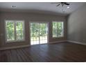 Bright, spacious living room with vaulted ceilings, modern ceiling fan and large windows at Tbd 6 Privetts Rd., Conway, SC 29526