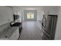 Bright kitchen with stainless steel appliances, granite countertops, and white cabinetry at Tbd 7 Privetts Rd., Conway, SC 29526