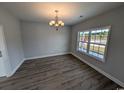 Well-lit dining room with gray walls, chandelier, and large windows offering scenic views at Tbd 9 Privetts Rd., Conway, SC 29526