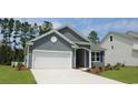 Charming home featuring a two-car garage, beautiful landscaping, and classic architectural details at 124 Fair Meadow Ct., Loris, SC 29569
