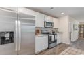 Modern kitchen featuring stainless steel appliances, white cabinets, and wood-look floors at 119 Cambridge Dr., Tabor City, NC 28463