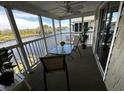 Relaxing screened balcony with water view, ceiling fan, seating, and sliding glass door entry at 220 Landing Rd. # I, North Myrtle Beach, SC 29582