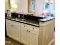 Kitchen sink with black granite countertops and white cabinets at 9550 Shore Dr. # 925, Myrtle Beach, SC 29572