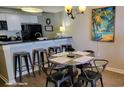 Dining area with industrial style table and chairs. The kitchen includes white cabinets and black appliances at 9550 Shore Dr. # 925, Myrtle Beach, SC 29572