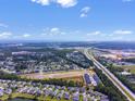 Expansive aerial shot of a community with a highway and distant ocean view at 293 Sandridgebury Dr. # 66, Little River, SC 29566