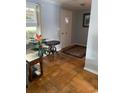 Cozy entryway with hardwood floors, accented by a decorative rug, potted plants, and natural light at 660 Cardinal Ave. # 660, Myrtle Beach, SC 29577