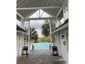 Community pool area featuring palm trees, cabana, lounge chairs and shade, and trash cans at 1521 James Island Dr., North Myrtle Beach, SC 29582