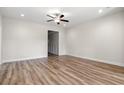 Bright, airy bedroom featuring wood-look floors, neutral paint, and a ceiling fan at 623 Carter Reid Ct., Longs, SC 29568