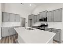 Modern kitchen with gray cabinets, white countertops, and stainless steel appliances at 1127 Cypress Shoal Dr., Conway, SC 29526