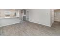 Bright living space featuring modern gray wood-look floors, and a view of the kitchen at 204 Cambridge Dr., Tabor City, NC 28463