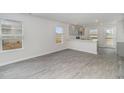 Bright living space features modern gray wood-look floors and plenty of natural light at 204 Cambridge Dr., Tabor City, NC 28463