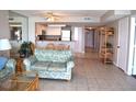 Comfortable living room with neutral tile floors, a ceiling fan, and open concept to the kitchen at 501 S Ocean Blvd. # 1104, North Myrtle Beach, SC 29582