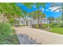 Inviting single-story home boasts a long driveway and lush landscaping at 5303 Pheasant Dr., North Myrtle Beach, SC 29582