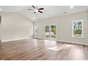 Bright living room with wood floors, vaulted ceiling, and sliding glass doors to the backyard at 639 Carter Reid Ct., Longs, SC 29568