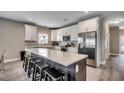 Bright kitchen featuring a large island with seating, white cabinets, and stainless steel appliances at 113A 12Th Ave. S, Surfside Beach, SC 29575