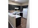 Galley kitchen with dark cabinets and white appliances at 1286 River Oak Dr. # 8-I, Myrtle Beach, SC 29579