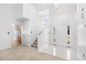 Bright foyer with a two-story ceiling, staircase, and tiled entry, leading to other rooms at 2513 Hunters Trail, Myrtle Beach, SC 29588